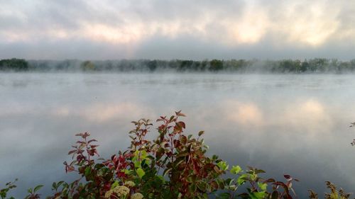 Scenic view of lake against cloudy sky