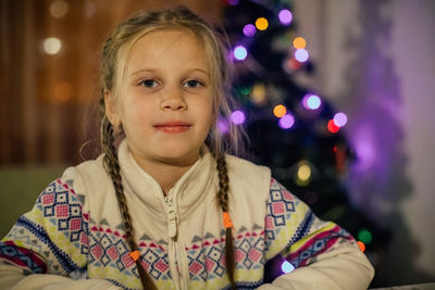 Portrait of girl against christmas tree