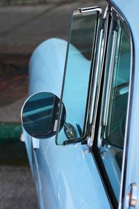 Side-view mirror of blue vintage car