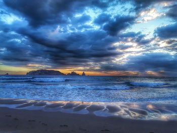 Scenic view of sea against dramatic sky