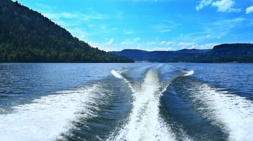 Wave from a boat on a lake high in the mountains in summer, summer day