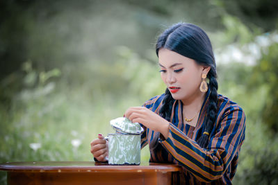 Young woman drinking water from bottle