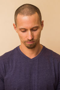 Close-up portrait of young man against white background