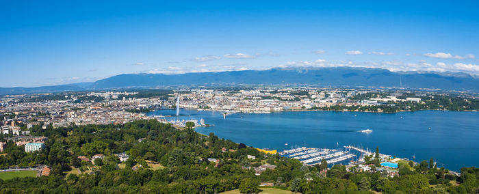 High angle view of city by sea against sky