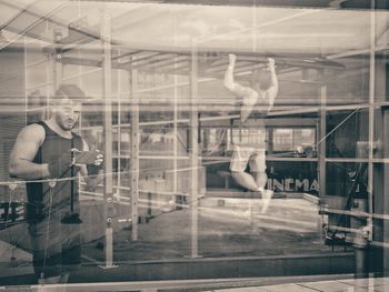 Digital composite image of man photographing glass