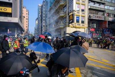 People on city street during rainy season