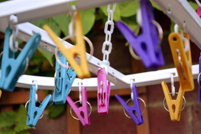 Close-up of clothespins hanging on clothesline