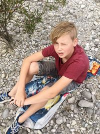 Young boy sitting on rocks