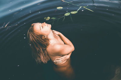 High angle view of naked woman in lake