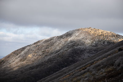 Low angle view of rock formation against sky