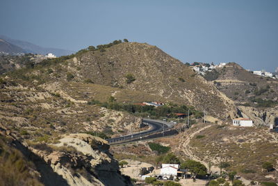 Panoramic view of road amidst buildings against clear sky