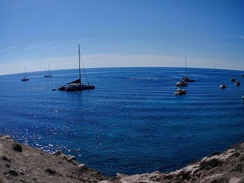 Sailboats on sea against sky