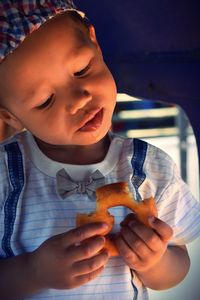 Close-up of boy holding food