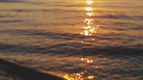 Scenic view of lake against sky at sunset