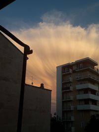 Low angle view of building against sky at sunset