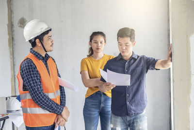 Group of people standing against wall