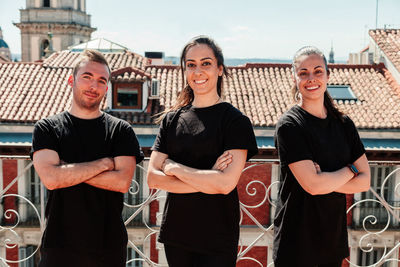 Fitness equipment of three young women on a terrace looking at the camera