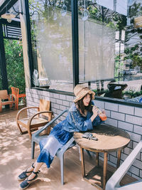 Woman sitting on table at cafe