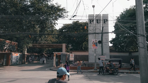 People riding bicycle on road in city