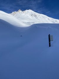 Snowcapped mountains against blue sky