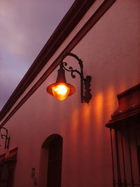 Low angle view of illuminated lamp against sky