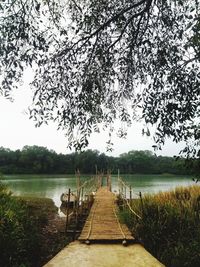 Scenic view of pier over lake against sky