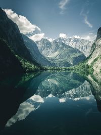 Scenic view of lake and mountains against sky