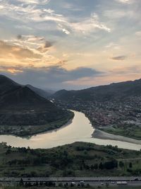 Scenic view of river against sky during sunset