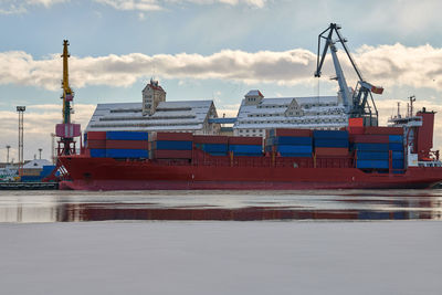 Moored cargo ships and harbor cranes in port. seaport, cargo container yard, container ship terminal