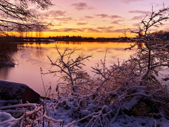 Scenic view of lake against orange sky