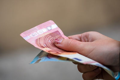 Close-up of hand holding paper