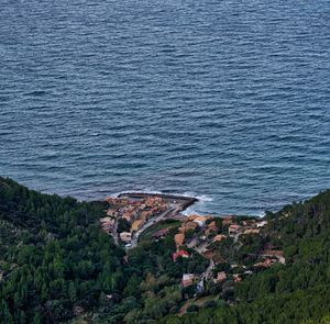 High angle view of buildings by sea