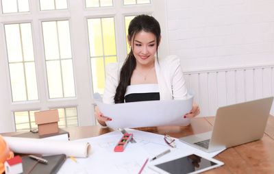 Young woman using laptop on table