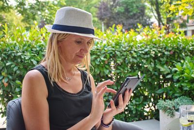 Midsection of woman using mobile phone