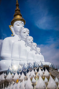 Low angle view of statue against building against sky