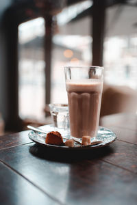 Close-up of coffee in glass on table