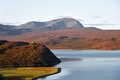 Scenic view of lake and mountains against sky