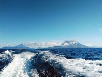 Scenic view of sea against clear blue sky