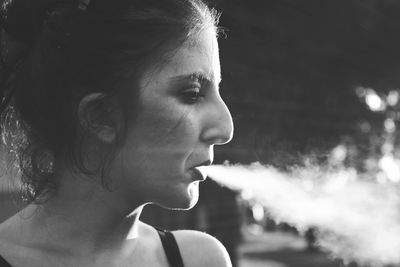 Close-up of young woman smoking