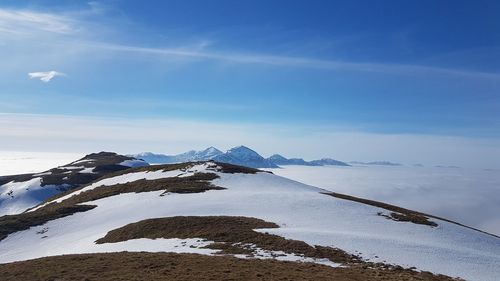 Scenic view of snowcapped mountains against sky