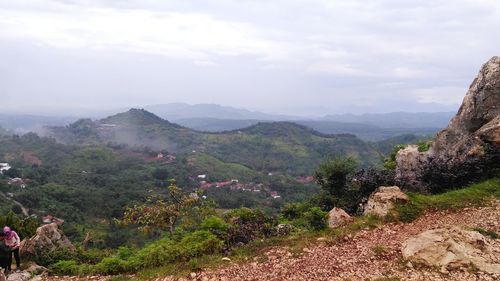 Scenic view of landscape against cloudy sky