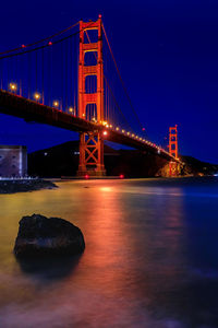 Low angle view of suspension bridge at night