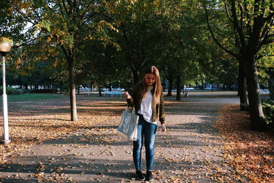 Young woman in park during autumn