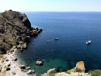 High angle view of sailboats on sea shore against sky