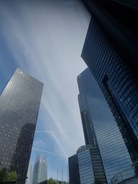 Low angle view of modern buildings in city against sky