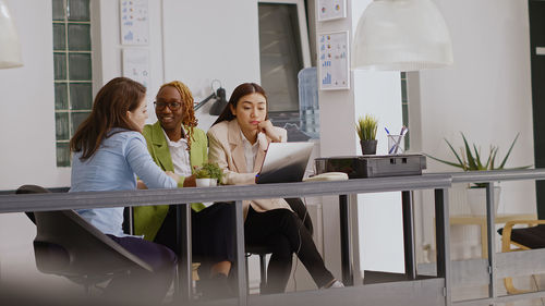 Female friends standing in office