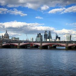 View of bridge over river with city in background