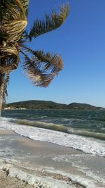 Scenic view of beach against clear sky