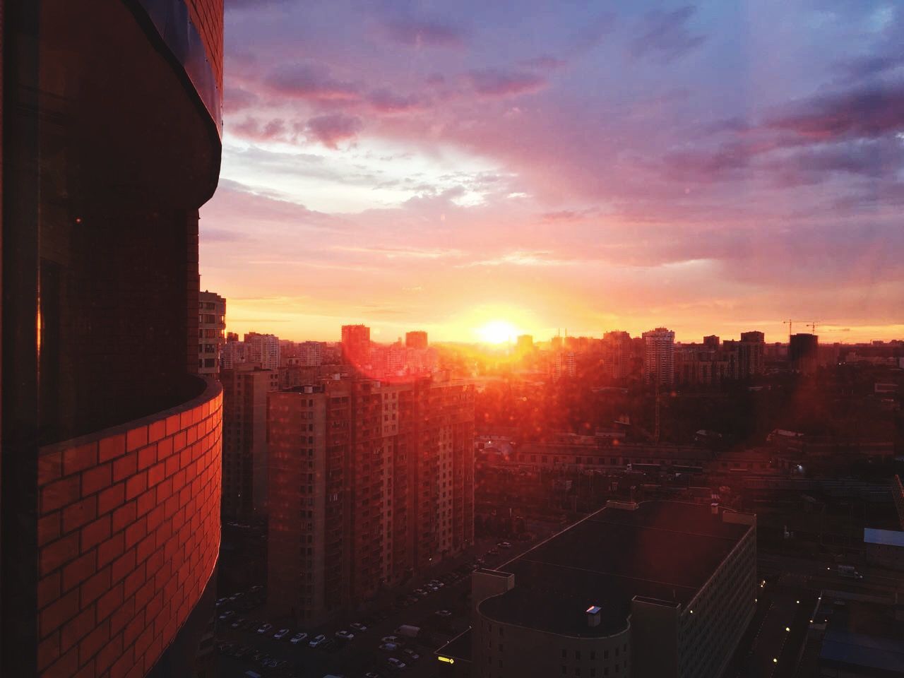 architecture, built structure, building exterior, city, sunset, sky, building, cityscape, nature, sun, cloud - sky, sunlight, no people, office building exterior, orange color, lens flare, residential district, city life, outdoors, skyscraper