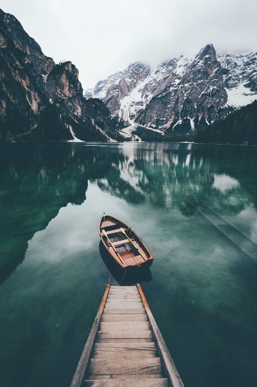 mountain, water, scenics - nature, lake, beauty in nature, tranquility, tranquil scene, reflection, mountain range, wood - material, nature, day, non-urban scene, sky, no people, nautical vessel, transportation, cold temperature, outdoors, snowcapped mountain